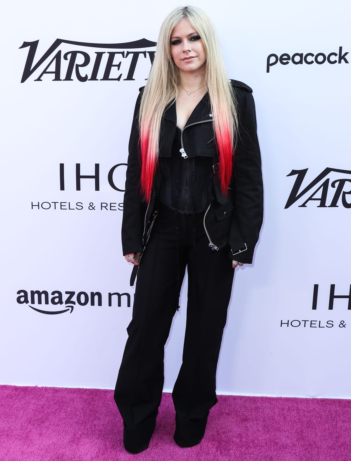 Avril Lavigne exudes rock-chic confidence in an all-black ensemble and platform boots at the 2021 Variety Music Hitmakers Brunch in Los Angeles, pairing sleek tailoring with her signature bold streaks of color