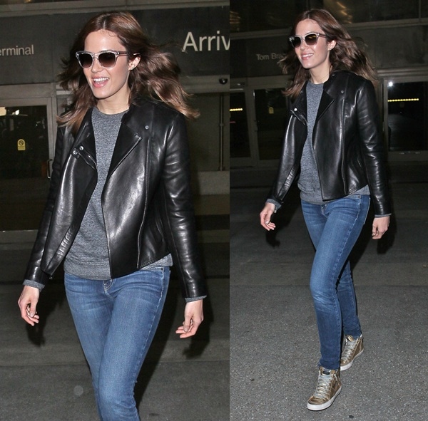 Mandy Moore in blue jeans paired with a leather jacket and a gray sweater at LAX