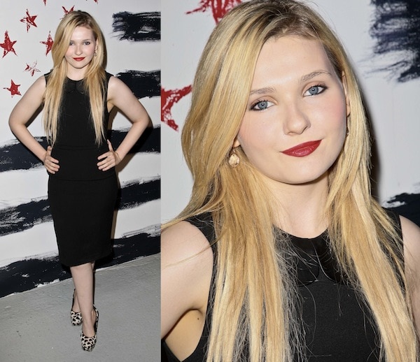 Abigail Breslin attends Alice + Olivia's Spring/Summer 2013 presentation during Mercedes-Benz Fashion Week in New York City on September 10, 2012, wearing a fitted black dress paired with the brand's playful heart-print pumps, a polished look that balanced youthful charm with growing red-carpet sophistication