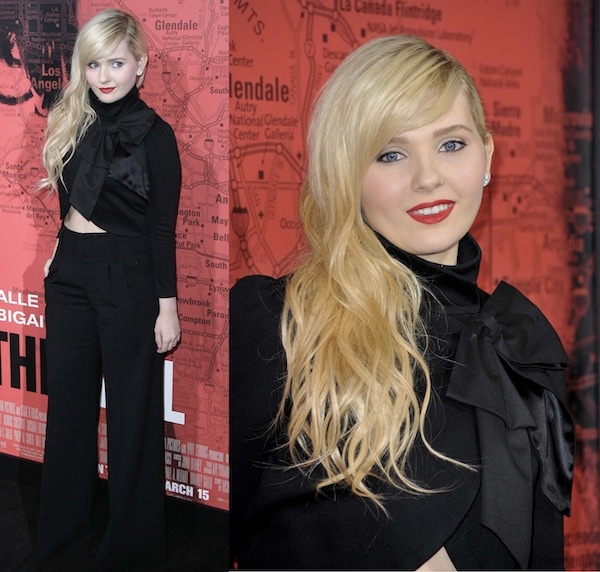 At the Los Angeles premiere of The Call on March 5, 2013, Abigail Breslin paired a dramatic black blouse featuring an oversized bow with high-waisted wide-leg trousers, creating one of her most fashion-forward red-carpet looks of the era