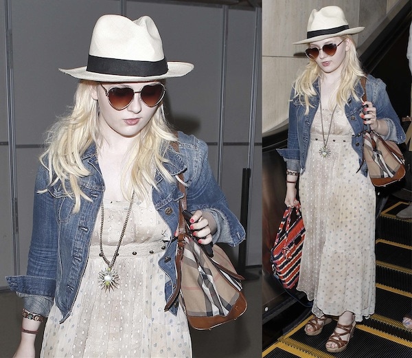 Abigail Breslin arrives at Los Angeles International Airport on July 21, 2013, channeling a relaxed bohemian aesthetic in a printed maxi dress layered with a cropped denim jacket, a fedora, oversized sunglasses, and a statement pendant necklace