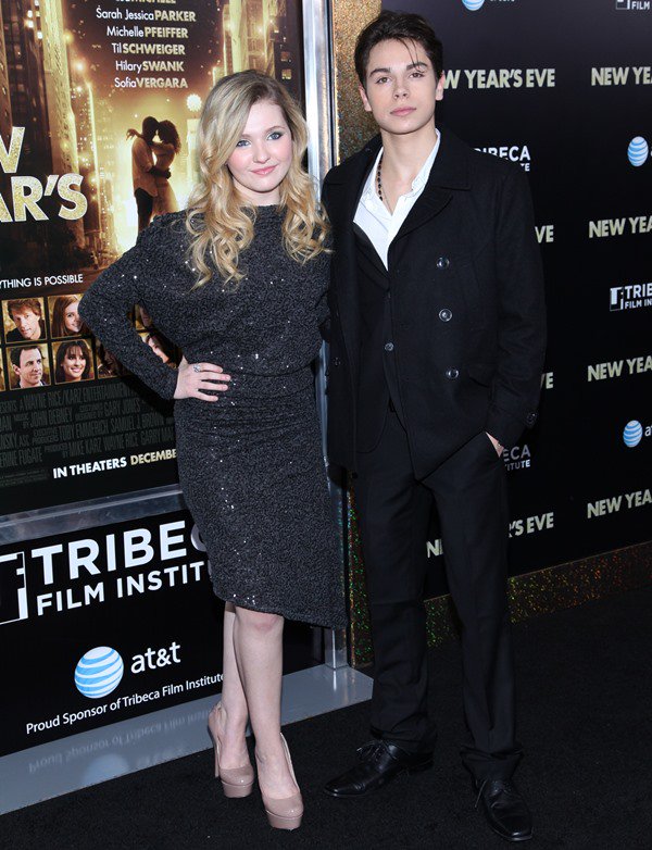 Joined by Jake T. Austin at the New York premiere of New Year's Eve on December 7, 2011, Abigail Breslin wore a sparkling black L'Agence dress, posing alongside co-star Jake T. Austin while embracing a more polished and mature red-carpet style