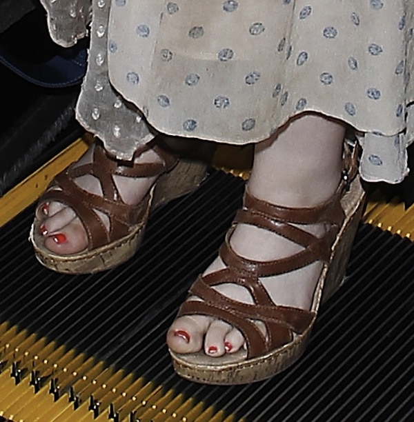 Completing the travel-ready ensemble, Abigail wore BOC by Born "Brygida" wedge sandals, a strappy brown style with a cork-inspired platform that complemented the outfit's laid-back summer feel