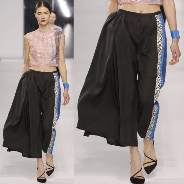 Dior's charcoal wool pants from the Resort 2014 collection, highlighted by exquisite guipure lace detailing — a blend of sophistication and avant-garde style