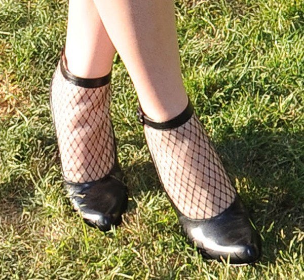 A closer look at Hailee’s Louboutin ankle booties reveals their netted panels and curved toe design that blend playful texture with classic Parisian polish
