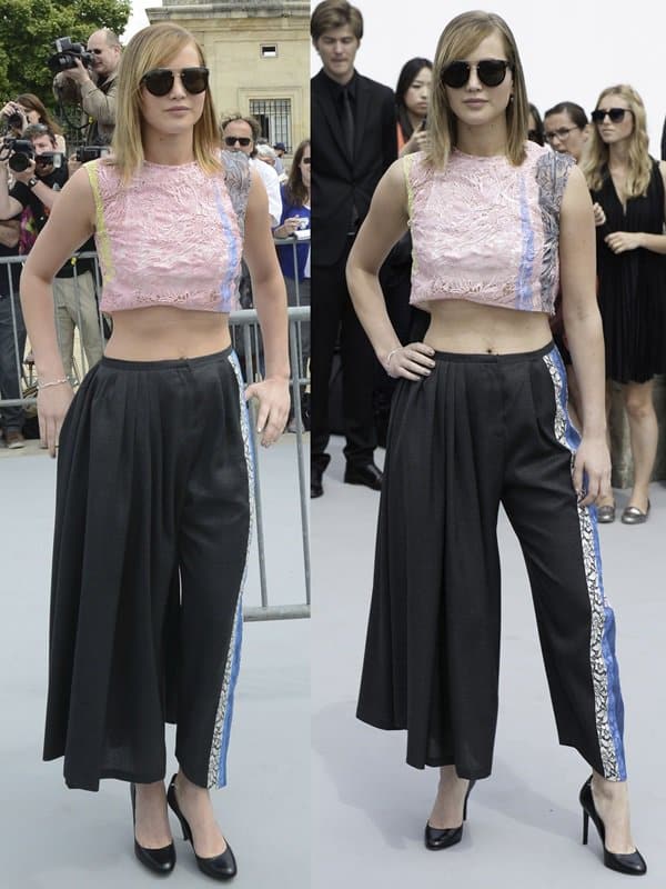 Jennifer Lawrence sharpens her Dior Resort 2014 look with classic black round-toe pumps, letting the clean lines of her heels anchor the fluid charcoal wool pants
