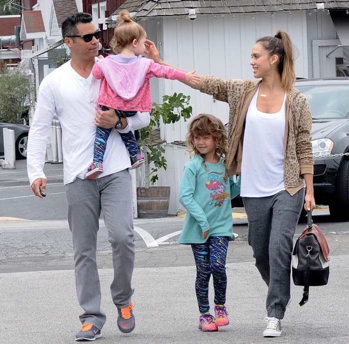 Jessica Alba embraces off-duty style in a leopard-print hoodie, jogger pants, and metallic Converse sneakers while leaving a family brunch at Brentwood Country Mart on July 21, 2013