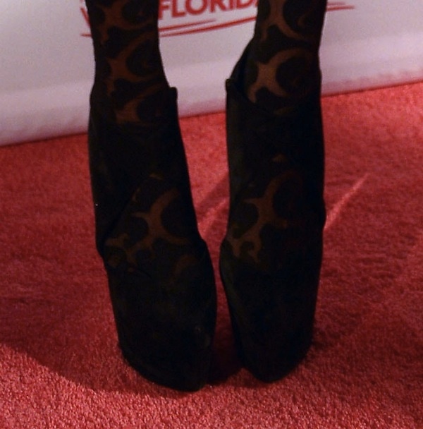 Kesha's Christian Louboutin Donue boots, featuring a distinctive platform and a blend of her signature edgy style with high-fashion flair, seen at the iHeartRadio Ultimate Pool Party