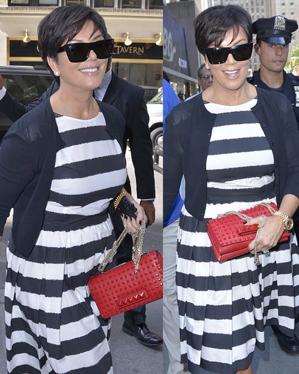 Kris Jenner dazzles in a striped monochrome Dolce Gabbana dress, complemented by a vibrant red Valentino purse, outside The Today Show