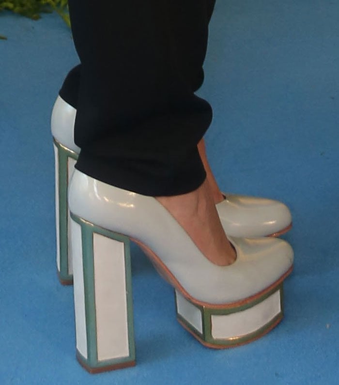 Maia Mitchell steps into bold retro style with Kat Maconie’s geometric block-heel pumps featuring glossy white panels and mint-green trim