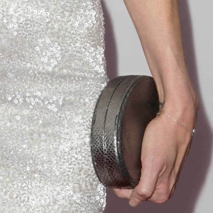 Mary-Louise Parker accessorized with a snake-embossed metallic pewter 'Lucca' oval clutch from Lauren Merkin