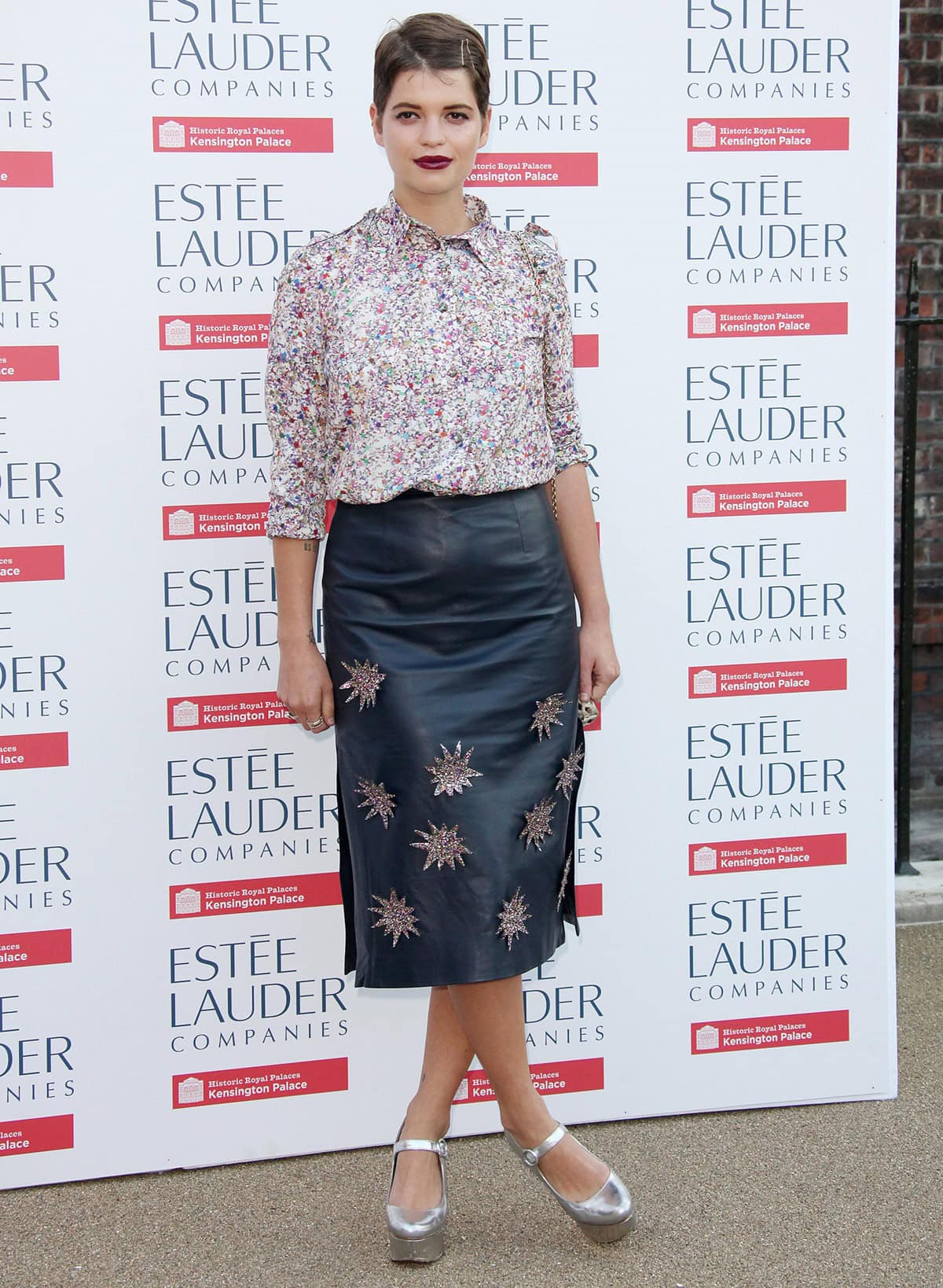 Pixie Geldof enlivened the Fashion Rules exhibition launch at Kensington Palace with a House of Holland teal leather skirt featuring starburst appliqués, coupled with a print blouse, glam rock silver Mary Janes, and an animal print Dolce Gabbana bag