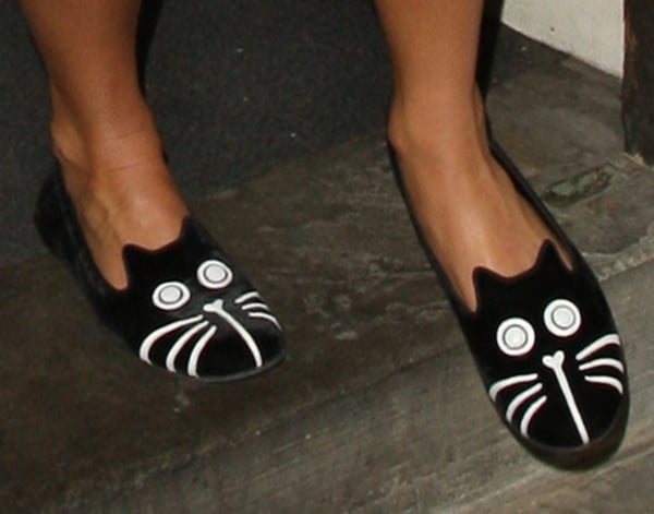 Pixie Lott adds a whimsical twist to her look with black velvet Marc by Marc Jacobs cat-face slippers featuring embroidered eyes, whiskers, and ears
