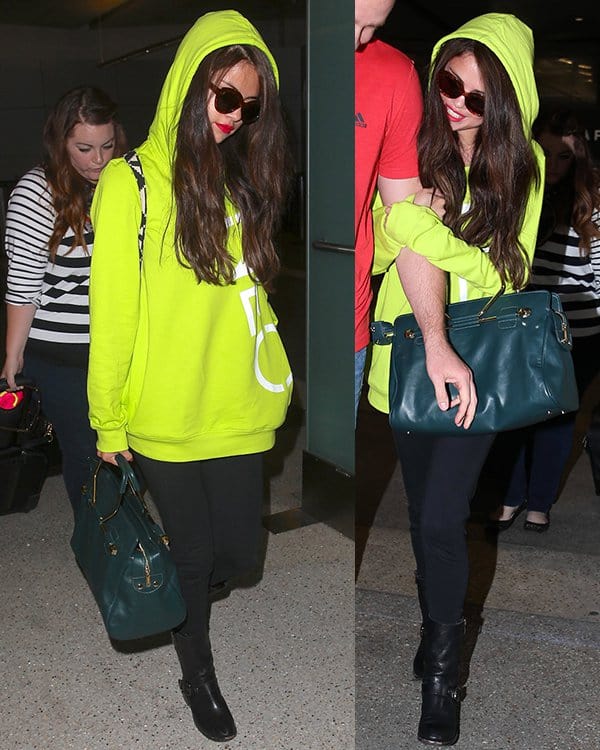 On July 10, 2013, at LAX Airport, Selena Gomez was seen wearing Vince Camuto Walt Stud boots, a Viktor  Rolf Bombette bag, Adidas Neo Selena Gomez leggings, an Adidas Neo logo hooded sweatshirt in intense lime/running white, and Elizabeth and James Taylor cat eye sunglasses