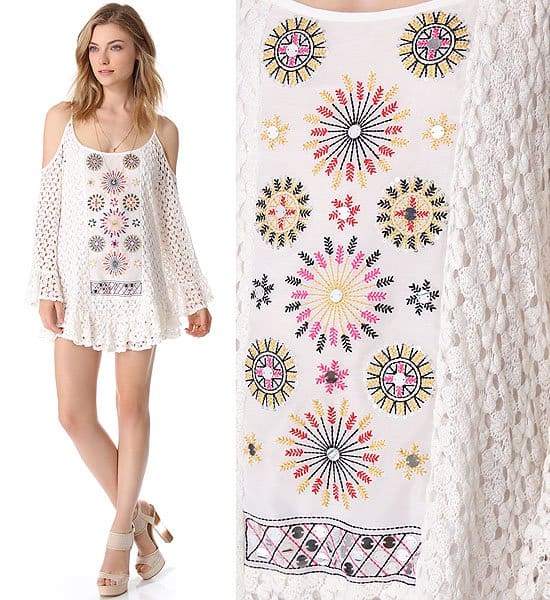 Model wears the same white crochet mini dress by Tbags Los Angeles that Solange Knowles styled in Croatia, featuring shoulder cutouts, flared sleeves, and colorful embroidered detailing — a perfect boho-chic summer look