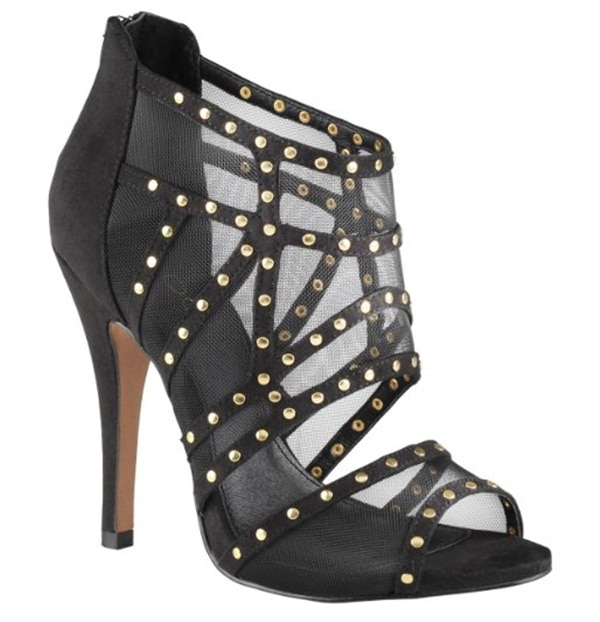 The black “Alysa” sandal stands out with its sculptural caged design, fine mesh inserts, and gold-tone stud embellishments, all balanced on a sleek high stiletto heel