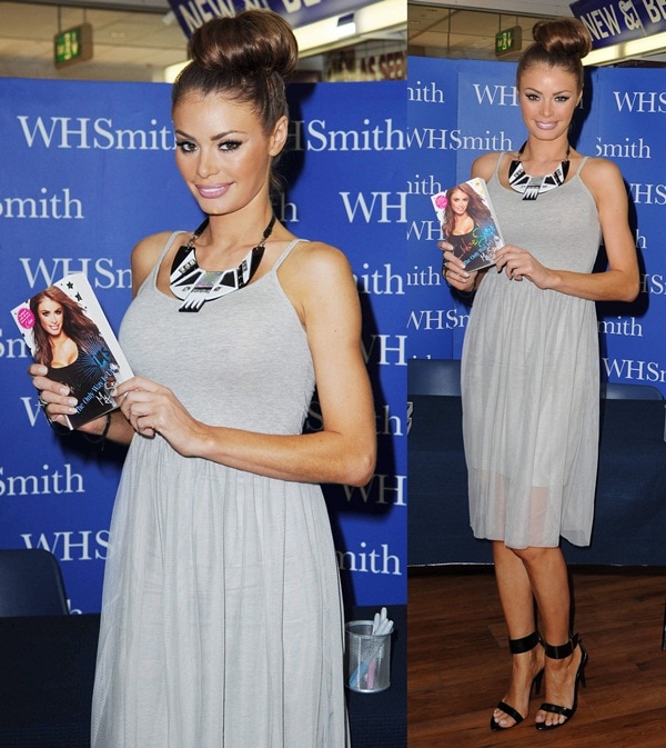 Chloe Sims balances a soft dove-gray tulle dress with sharp black ankle-strap heels, adding structure through a bold geometric statement necklace