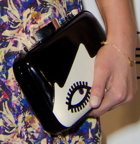 Close-up of Jenny Louise Coleman's Lulu Guinness 'Doll Face Fifi' clutch, featuring a bold black-and-white design with a playful eye motif and glossy patent finish