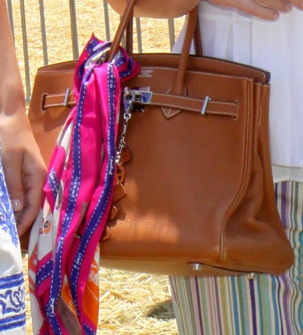 Kathy Hilton elevates her classic Hermès Birkin with a vibrant silk scarf, adding movement, color, and a touch of effortless Riviera-inspired polish