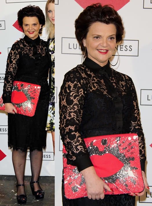 Lulu Guinness pairs a black lace midi dress and black peep-toe heels with her oversized 'In the Red Hug and Hold' clutch, featuring her signature red lips and bold sequin embellishments