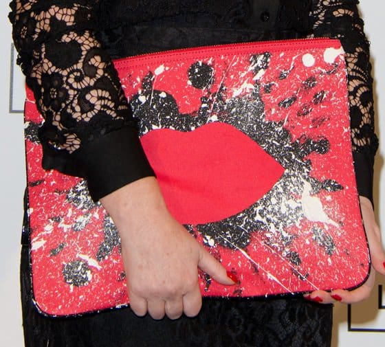 Close-up of Lulu Guinness’s 'In the Red Hug and Hold' clutch, featuring her signature red lips design with bold black-and-white paint-splatter sequin detailing