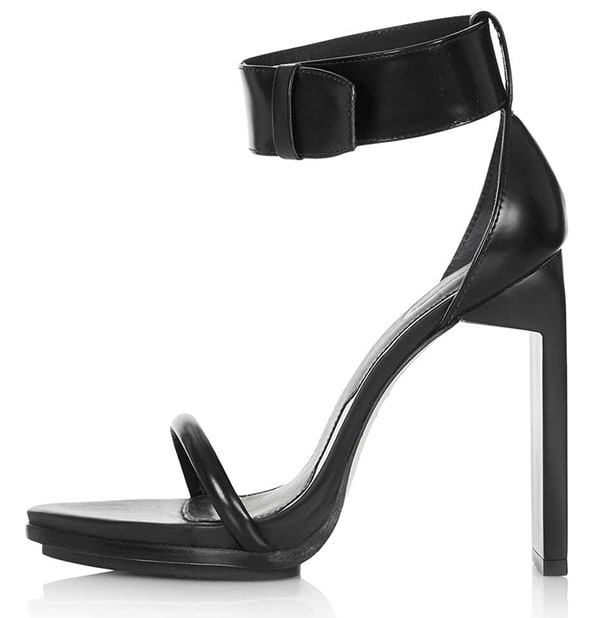Sleek and modern, Rita Ora's black ankle-strap Topshop sandals feature a streamlined open-toe silhouette and a tall, sculptural heel that adds polish while remaining versatile enough for day-to-night wear