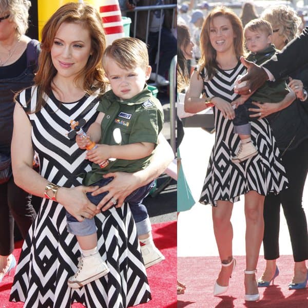 A radiant Alyssa Milano attended the 'Planes' premiere in Hollywood with her son Milo, who, clutching a toy plane, seemed less than thrilled with the paparazzi