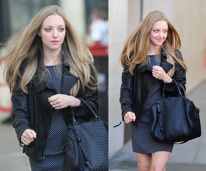 Amanda Seyfried arrives at BBC Radio One in London wearing a polka-dot Sachin + Babi mini dress, a black leather jacket, and a Bottega Veneta Intrecciato tote