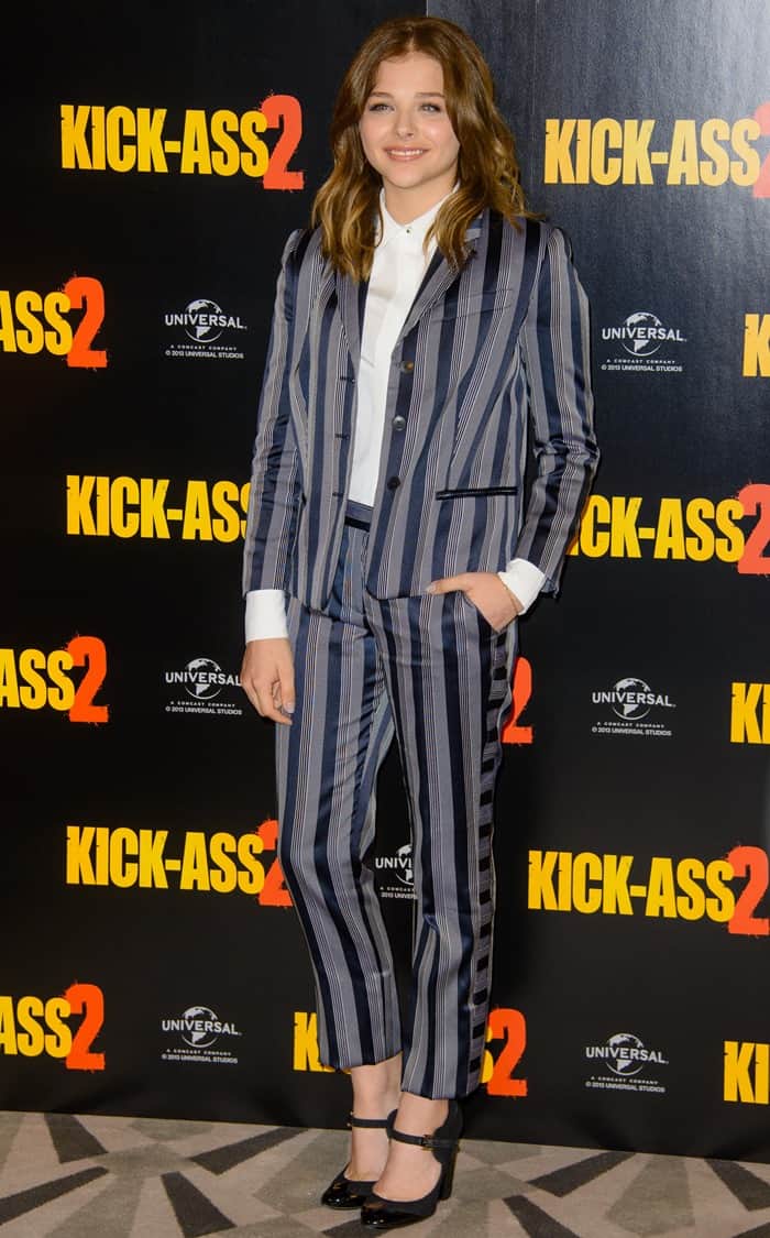 Chloë Moretz stylishly attends the 'Kick-Ass 2' photocall in London, showcasing a Viktor Rolf grey-and-navy striped suit