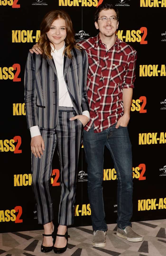 Chloë Grace Moretz and Christopher Mintz Plasse at the 'Kick-Ass 2' photocall, highlighting her effortless style in a casual hairstyle and chic ensemble