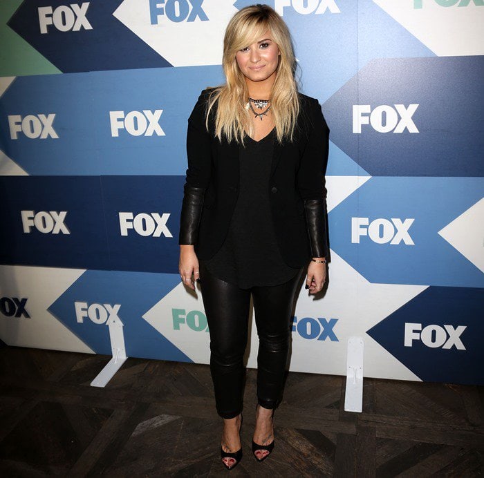 Demi Lovato attended the TCA Summer Tour: Fox All-Star Party on August 1, 2013, in a chic ensemble featuring an ATM Anthony Thomas Melillo slub V-neck tee, Rag Bone black leather-trimmed timeless blazer, Schutz Constance heels, and Theory Belisa L pants in Danish leather
