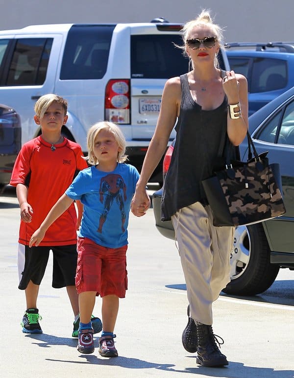 Gwen Stefani's sons dressed comfortably for the museum outing. Kingston wore a bright red athletic T-shirt with black shorts and green-accented sneakers, while Zuma sported a blue Spider-Man graphic T-shirt, red cargo shorts, and superhero-themed sneakers