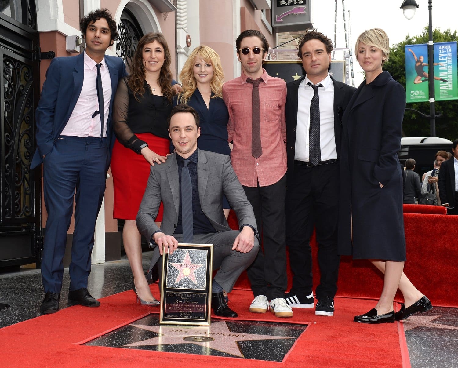 Actors Jim Parsons, Kunal Nayyar, Mayim Bialik, Melissa Rauch, Simon Helberg, Johnny Galecki, and Kaley Cuoco attend Parsons’ Hollywood Walk of Fame ceremony on March 11, 2015, where Cuoco opted for a sleek navy coat and glossy black loafers for the milestone moment