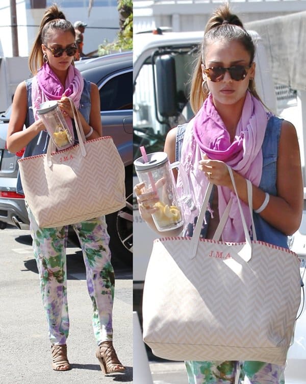 On August 21, 2013, in Los Angeles, Jessica Alba styled a plum-colored Nepali by TDM Design Bambi Lauren scarf with floral printed pants and brown cutout sandals, accessorizing with Lookmatic Marlowe sunglasses and a personalized Misela “Edna” chevron tote