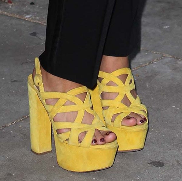Juno Temple flaunted a glossy burgundy pedicure in towering yellow Prada platform sandals, which added serious height thanks to their 5-inch block heels and 2-inch platforms