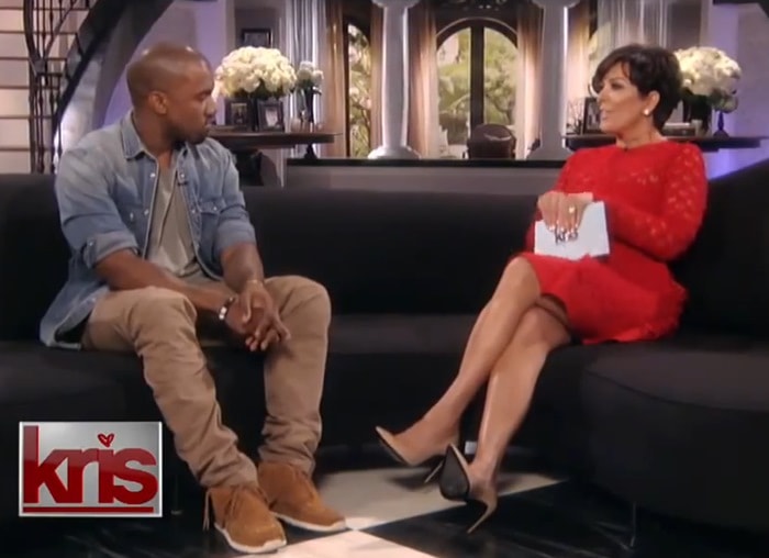 Kris Jenner wearing a red dress and nude Saint Laurent pointed-toe pumps while interviewing Kanye West on Kris in August 2013