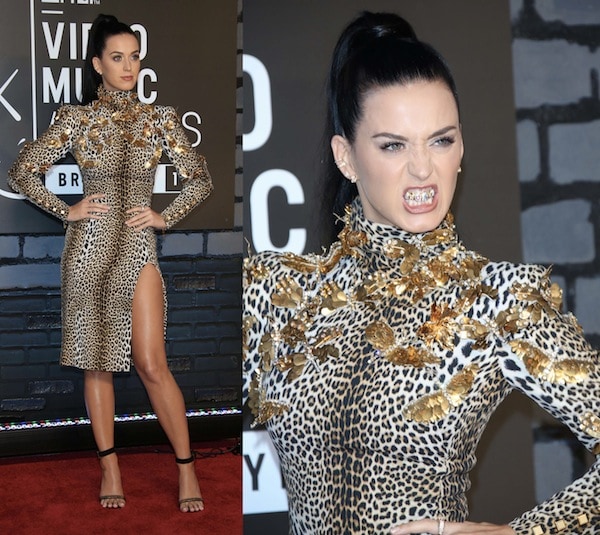 Katy Perry brought fierce energy to the MTV VMAs red carpet in a leopard-print Emanuel Ungaro dress adorned with gold butterflies, paired with simple Celine ankle-strap sandals and a bold grill to complete the wild look