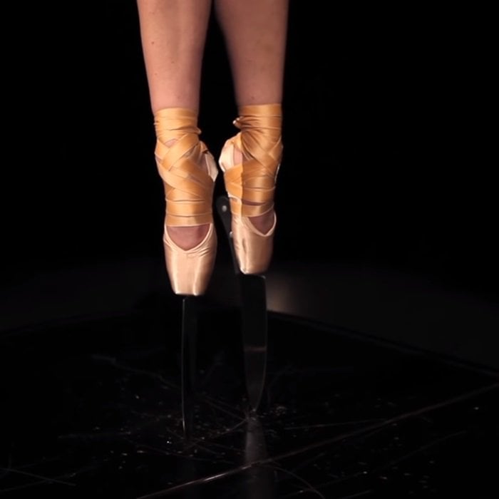 French dancer Amelie Segarra manages to maintain balance on the lid of a grand piano set on a stage