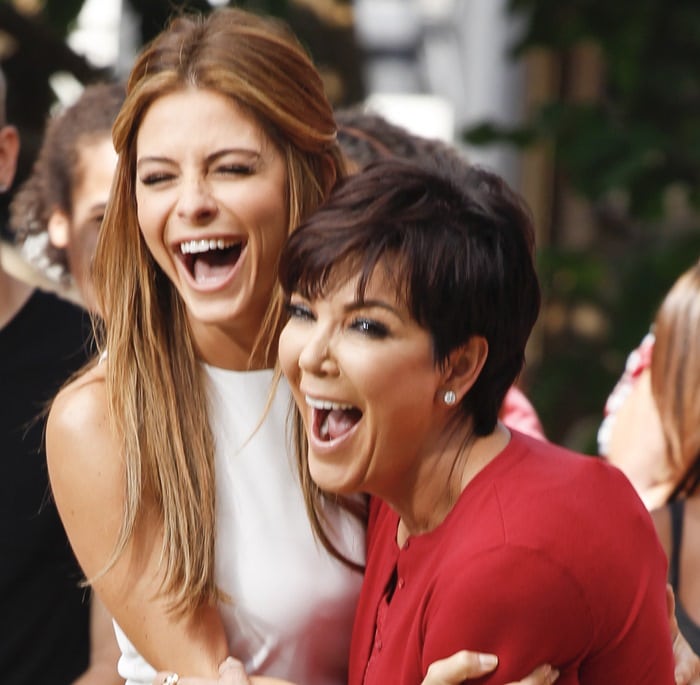 Kris Jenner laughing with Maria Menounos during an Extra interview in August 2013