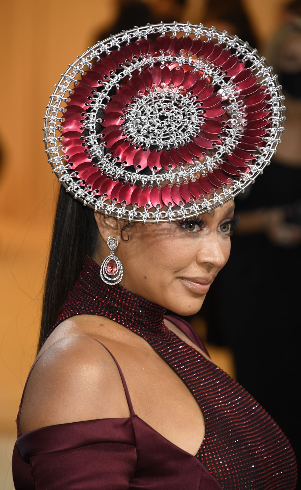 La La Anthony showcases her sculptural burgundy-and-silver Laurel DeWitt headpiece and sparkling David Yurman jewels at the 2022 Met Gala
