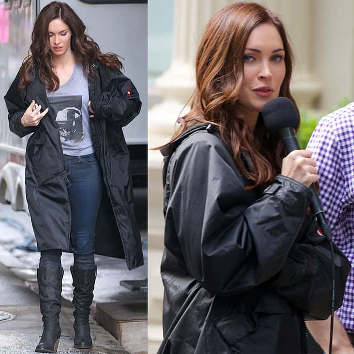 On June 14, 2013, Megan Fox filmed Teenage Mutant Ninja Turtles in New York City wearing a long black coat layered over skinny jeans and slouchy heeled boots, combining practical coverage with a streamlined, on-set silhouette