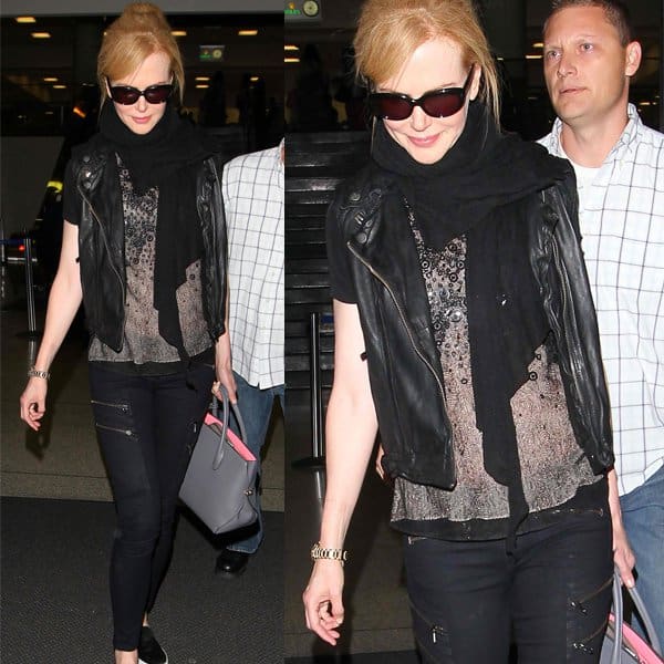 Nicole Kidman in an elegant all-black outfit featuring a Christian Dior purse and a pair of stylish Rag Bone zippered black denim jeans