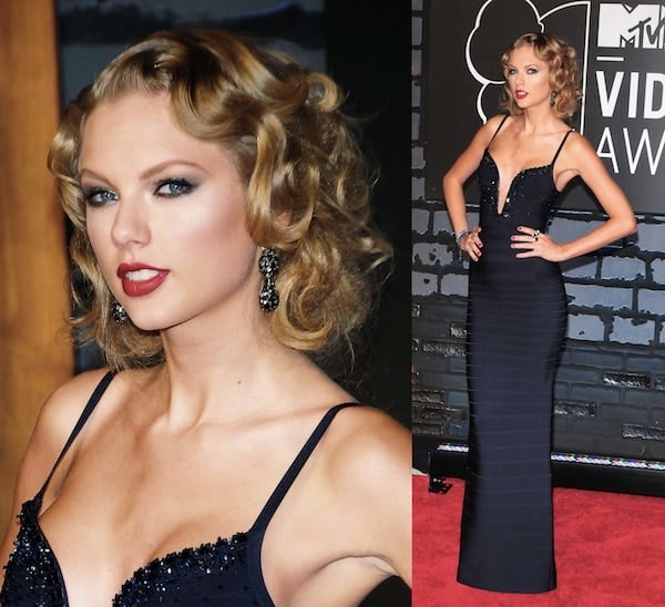 Taylor Swift channeled old Hollywood glamour at the MTV VMAs in a form-fitting navy Hervé Léger gown with a plunging neckline, complemented by vintage curls, bold red lipstick, and sparkling drop earrings