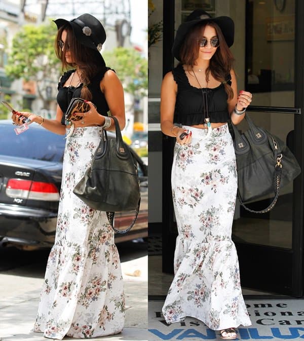 Vanessa Hudgens elegantly dons black sandals with a For Love Lemons attire featuring a 'Holy' floral maxi skirt and a 'Lisbon' top, showcasing her impeccable fashion sense