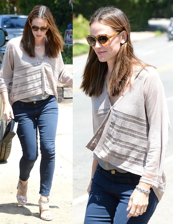 Jennifer Garner keeps it casual in a draped neutral top, indigo skinnies, and banded block-heel sandals while arriving at a private Brentwood gathering