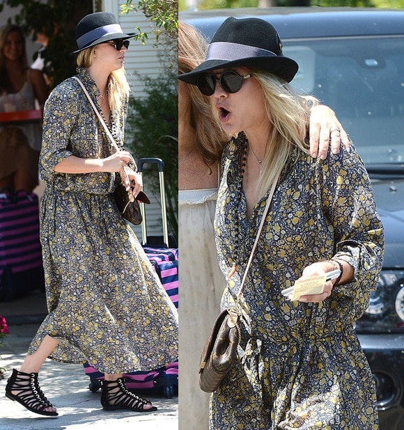 Kaley Cuoco keeps her look effortlessly boho in a printed midi dress, Louis Vuitton “Favorite MM” crossbody, and black Givenchy gladiator flat sandals while attending a party in Los Angeles on August 12, 2013