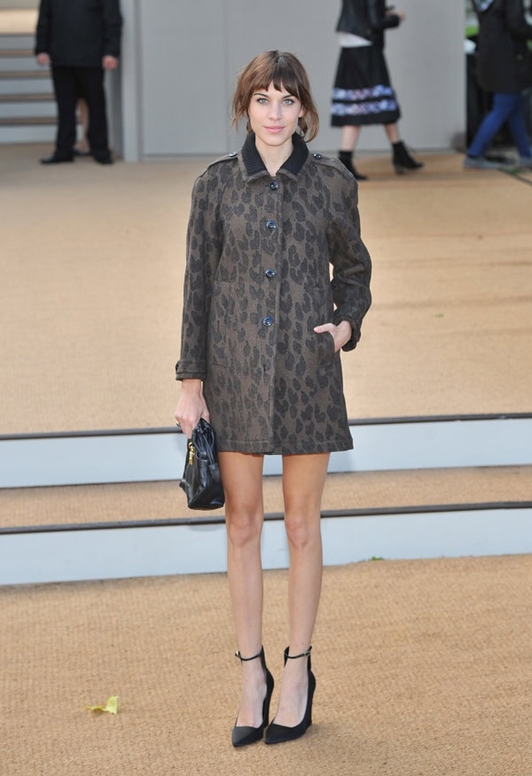 Alexa Chung channels retro sophistication in a leopard-print coat styled with classic black ankle-strap pumps and a sleek mini bag—perfectly capturing her signature vintage-inspired aesthetic
