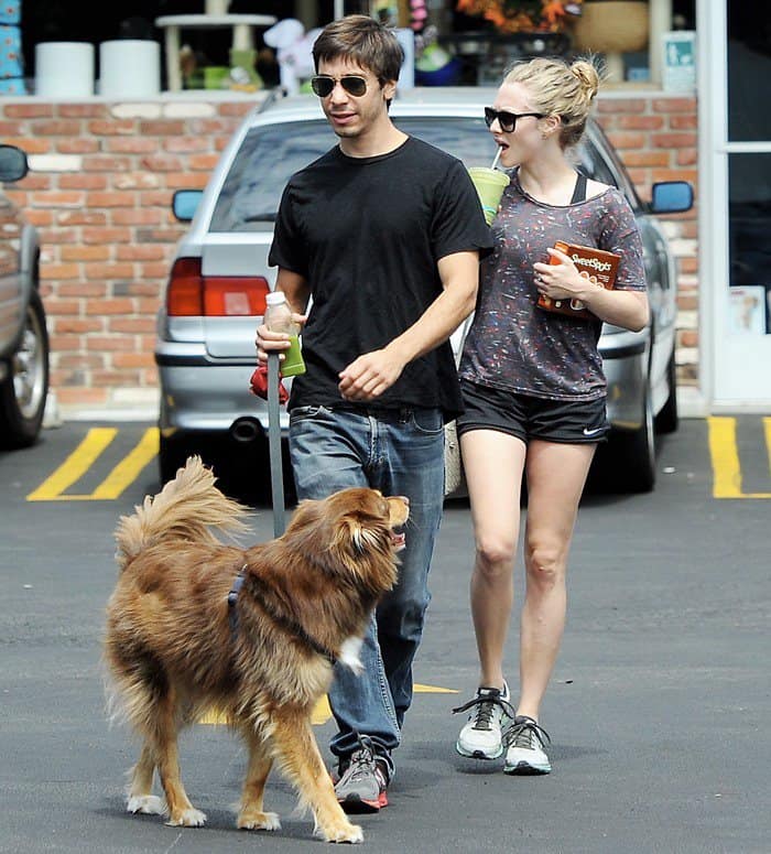Amanda Seyfried keeps it sporty in Nike running shoes, black athletic shorts, and a relaxed tee as she steps out for a casual dog walk with Justin Long in Los Angeles