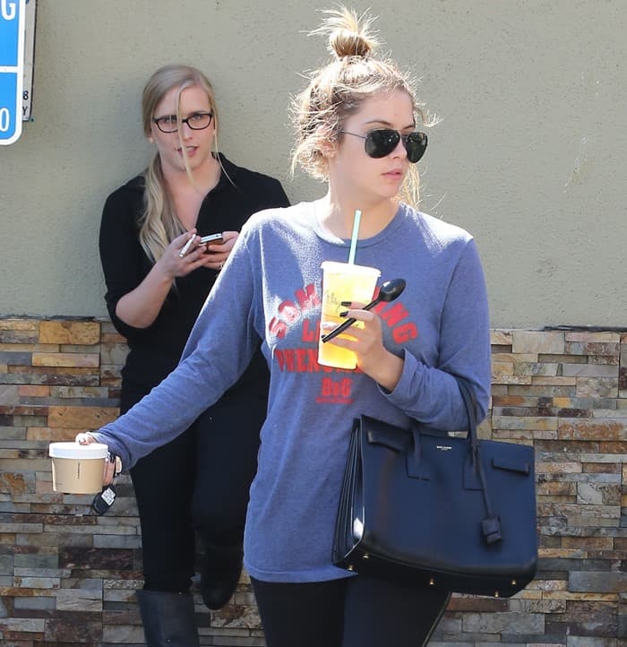 Ashley Benson frequently carries her elegant Saint Laurent bag, showcasing her effortless style