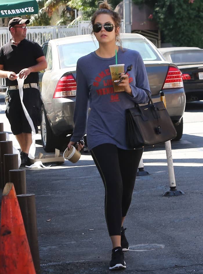 Ashley Benson keeps her off-duty look sleek and functional in Los Angeles on September 4, 2013, pairing a slouchy gray graphic sweatshirt and black leggings with streamlined black Nike sneakers that ground the outfit, while her structured Saint Laurent “Sac de Jour” tote adds a polished, high-fashion contrast